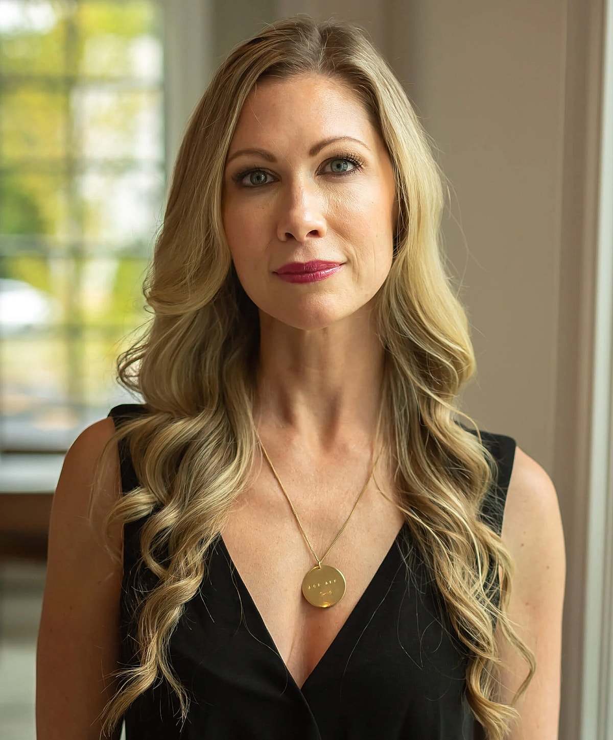 Woman with long hair in a stylish outfit.