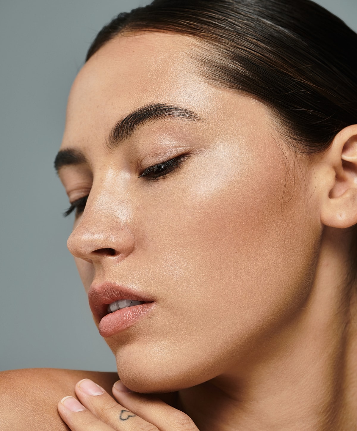 Close-up of a woman’s face with soft makeup.
