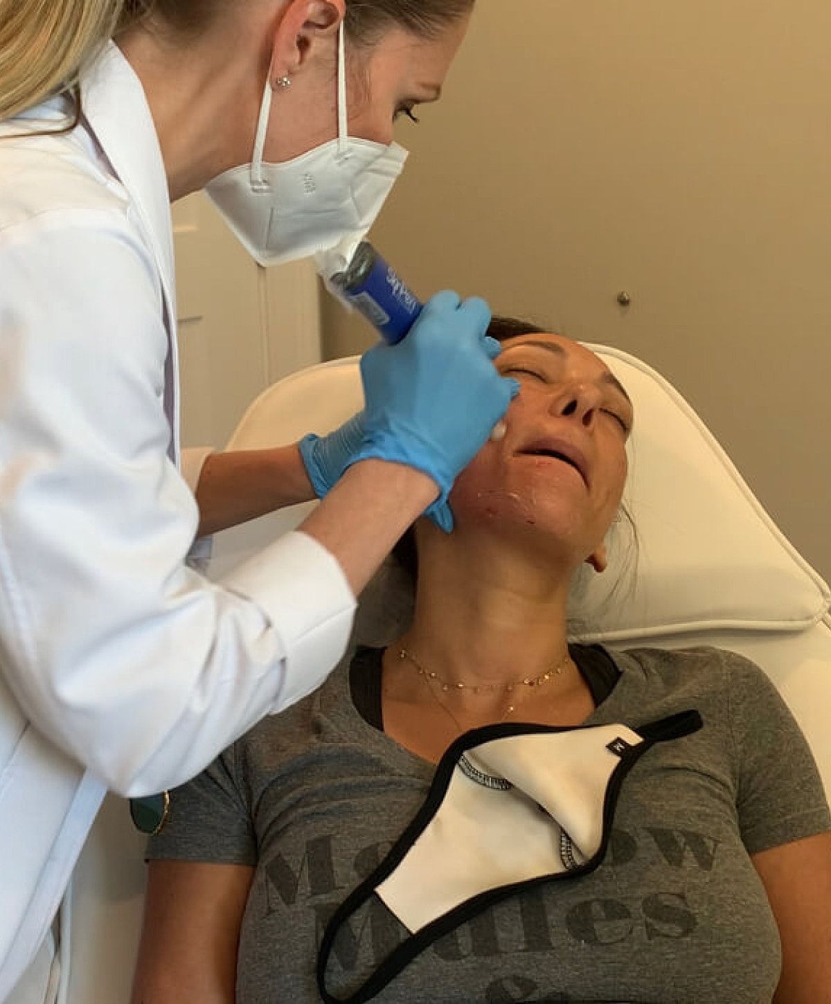 Facial treatment in progress at a clinic.