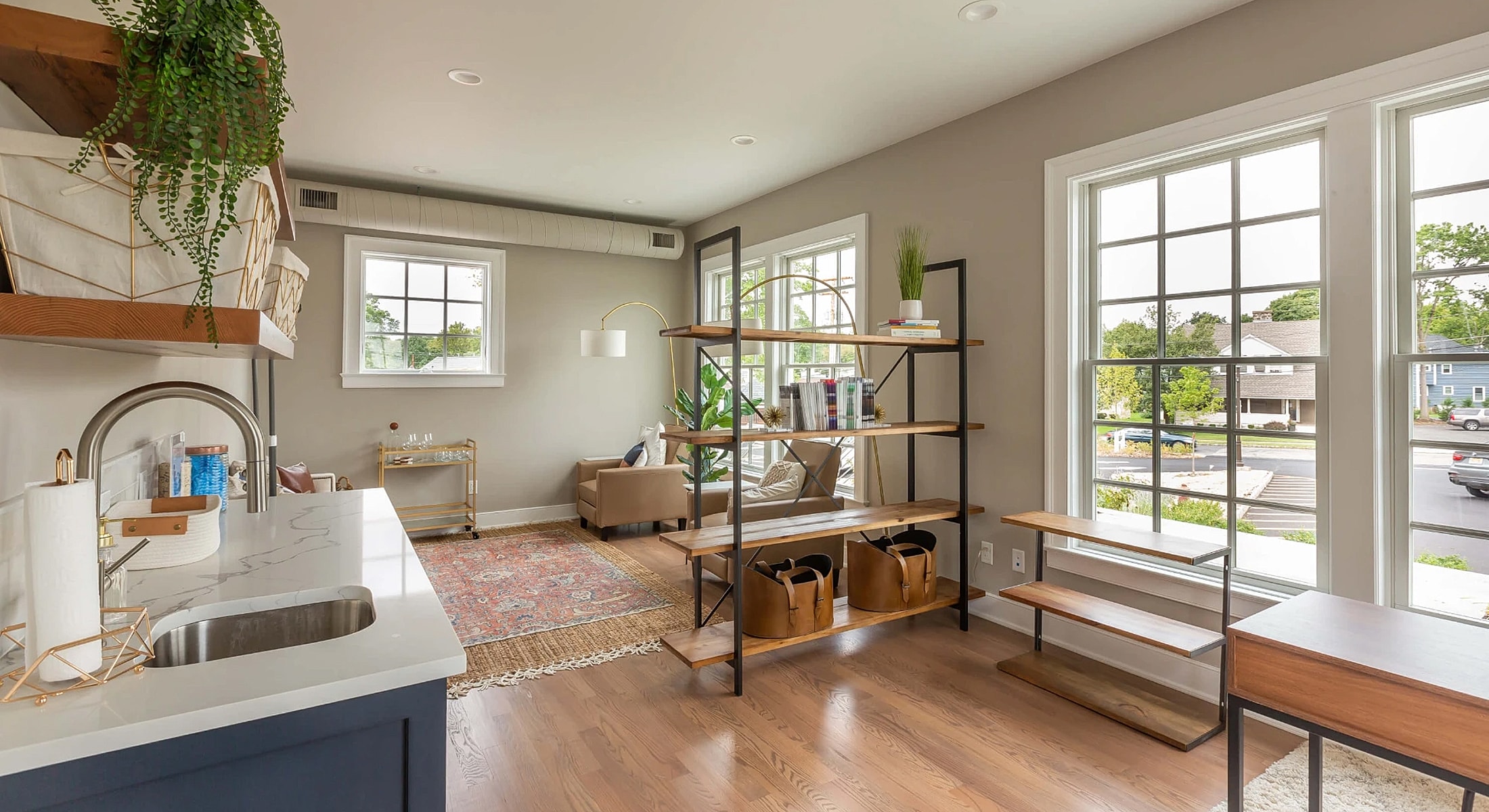 Modern living room with stylish shelving and windows.