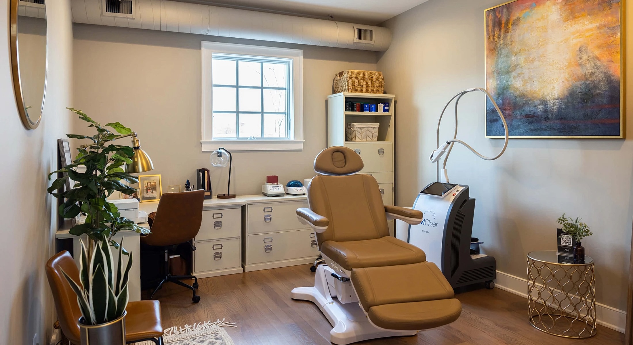 Modern aesthetic treatment room with therapeutic equipment.
