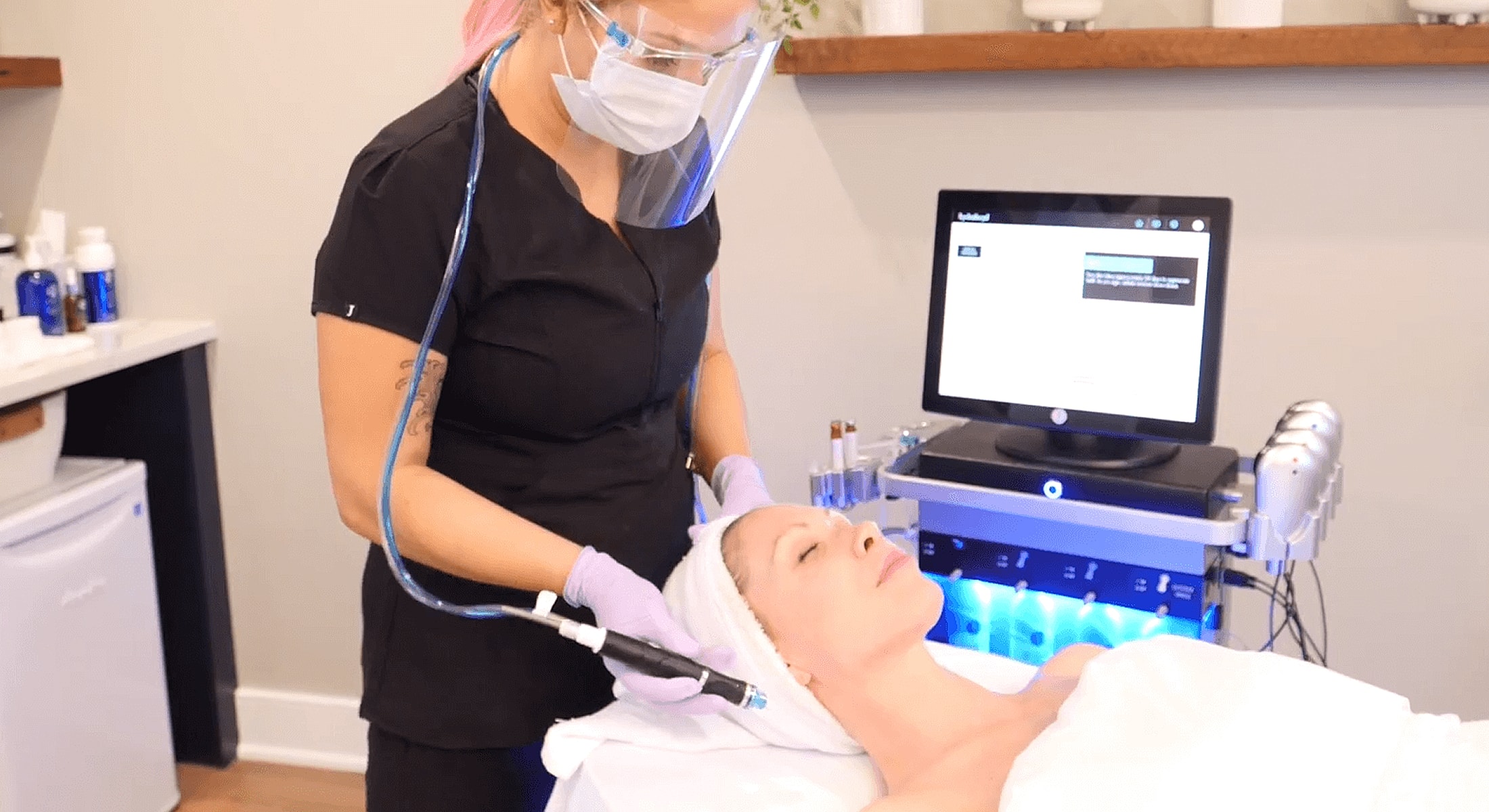 Woman receiving facial treatment in spa setting.