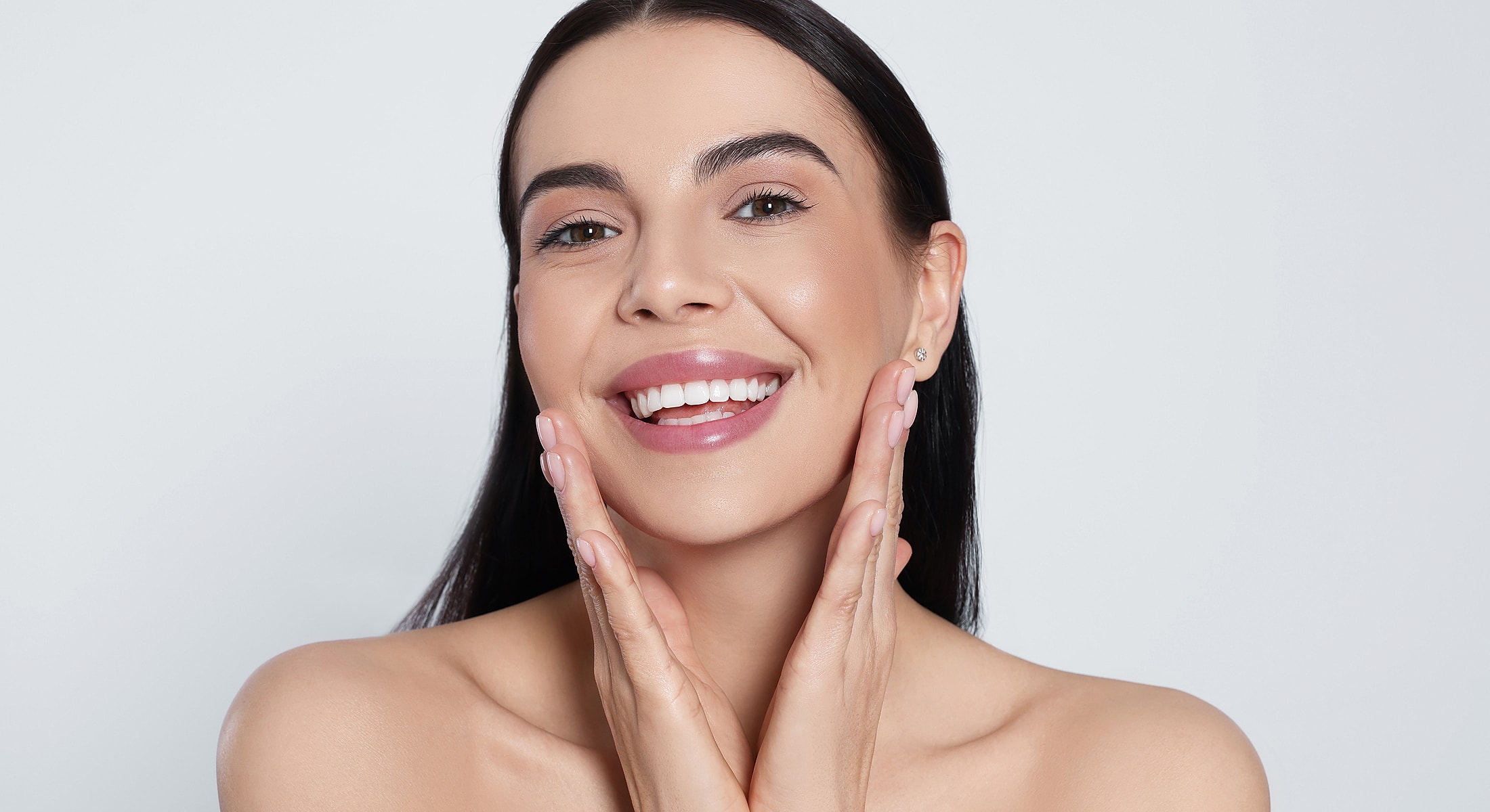 Smiling woman with healthy skin and glowing complexion