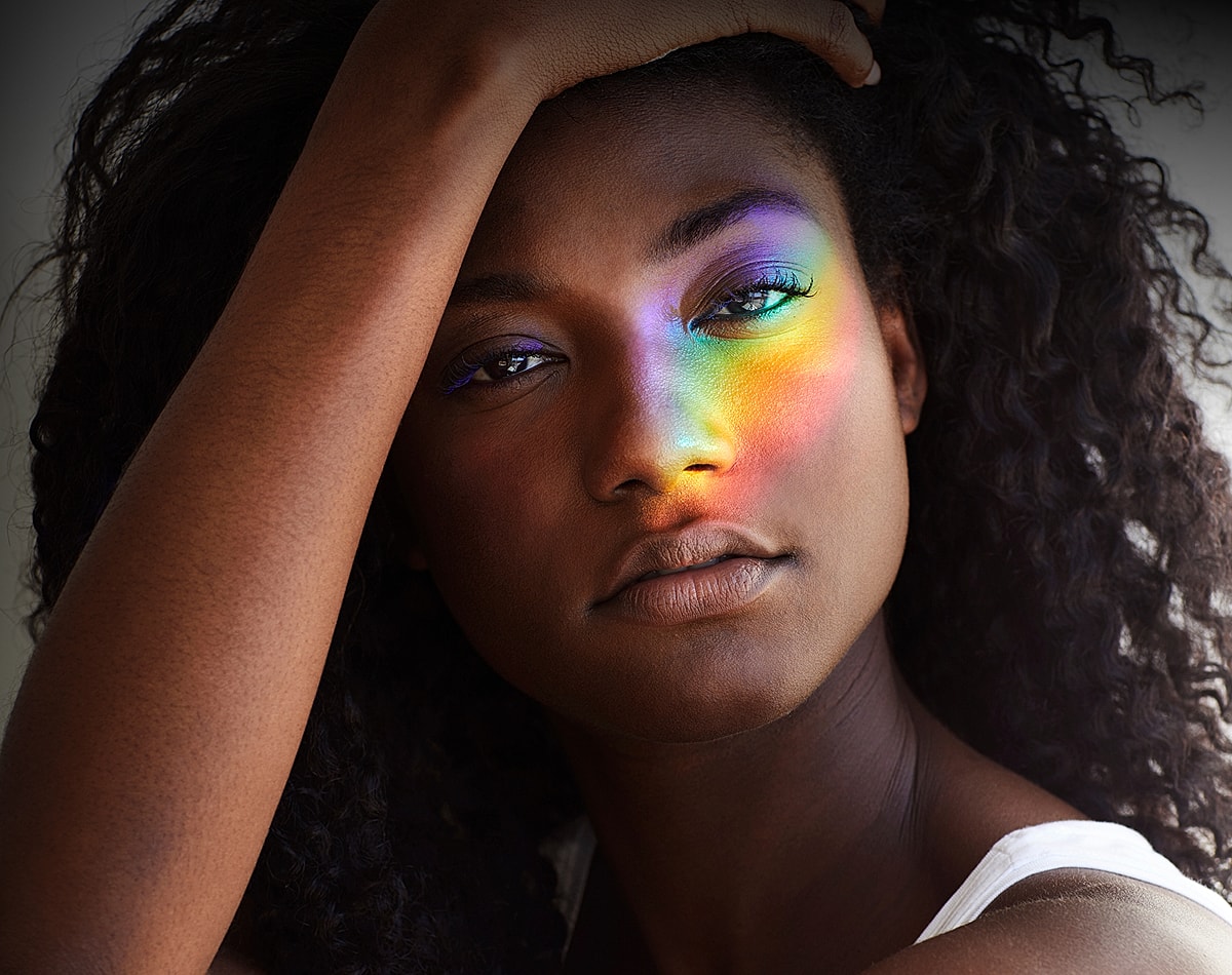 Portrait with rainbow light on face.