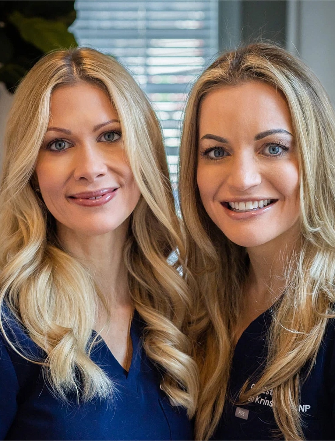Two women smiling in medical uniforms.